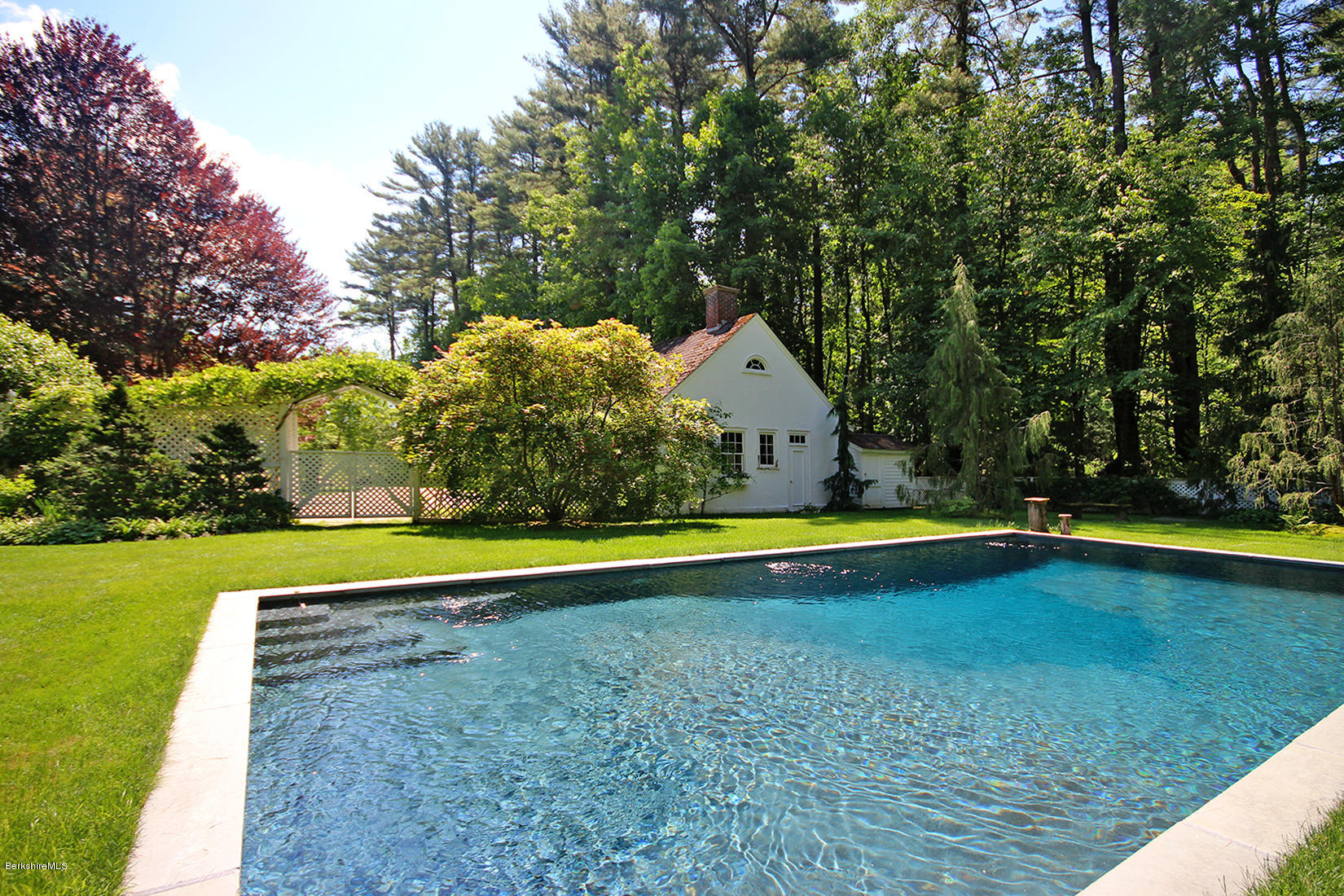 6 Glendale Road Stockbridge, MA 01229 - Photo 9 of 45 a view of a swimming pool with an outdoor space and seating area