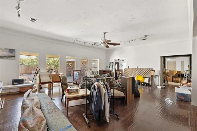 a living room with lots of furniture and wooden floor