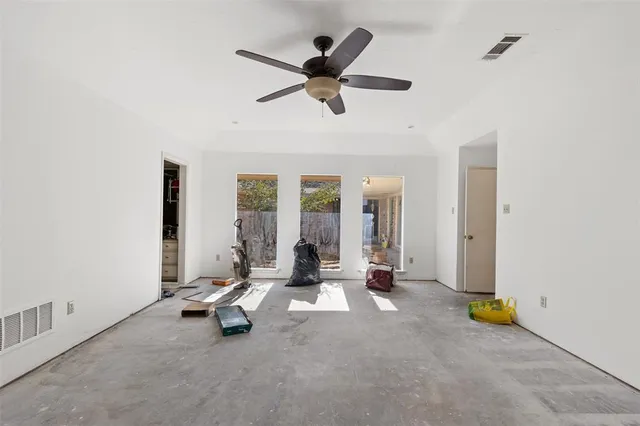 a room with lots of wooden furniture and a chandelier