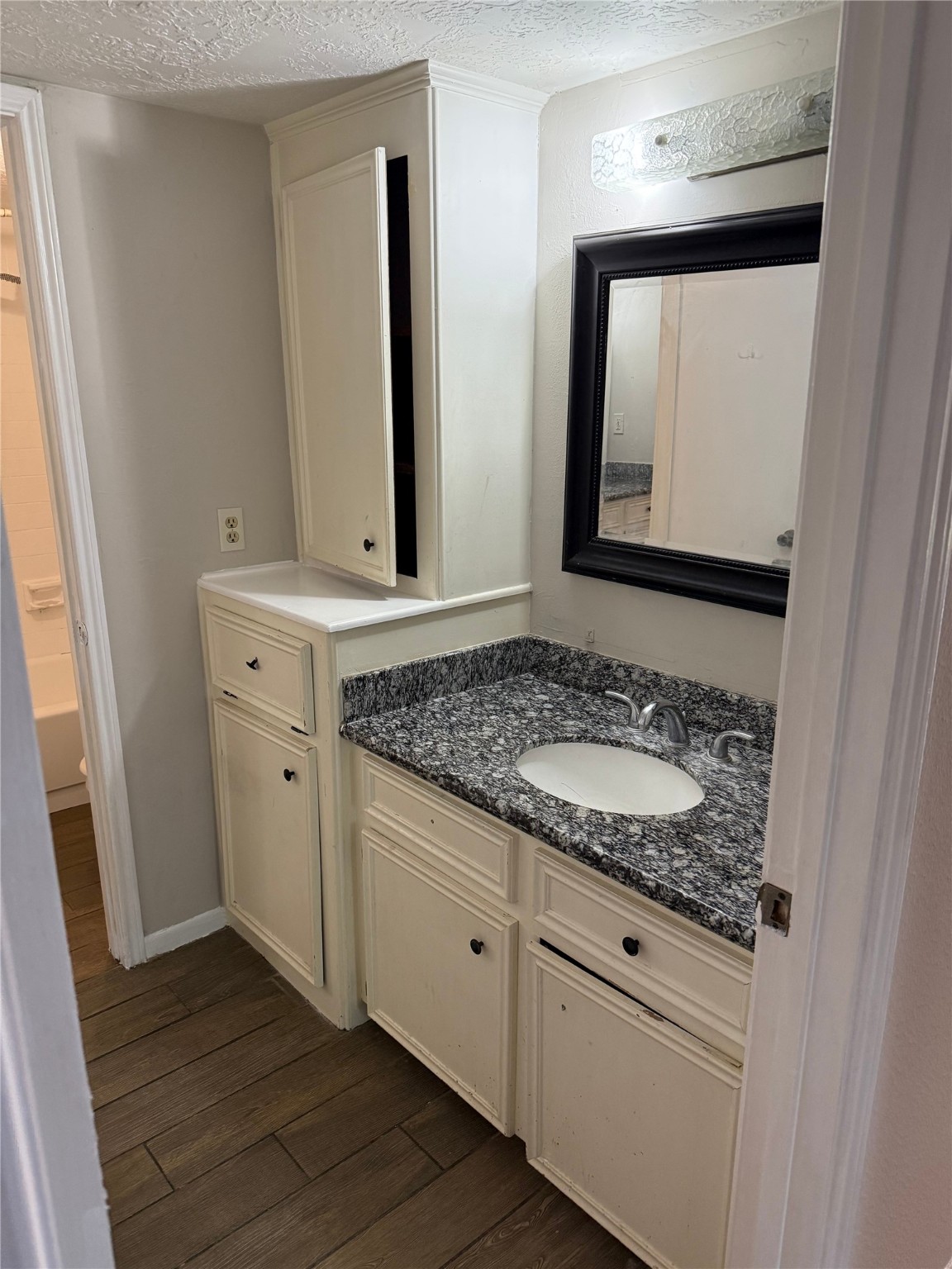 11500 Meadow Lane, Unit 4 Houston, TX 77477 - Photo 11 of 13 a bathroom with a granite countertop sink and a mirror