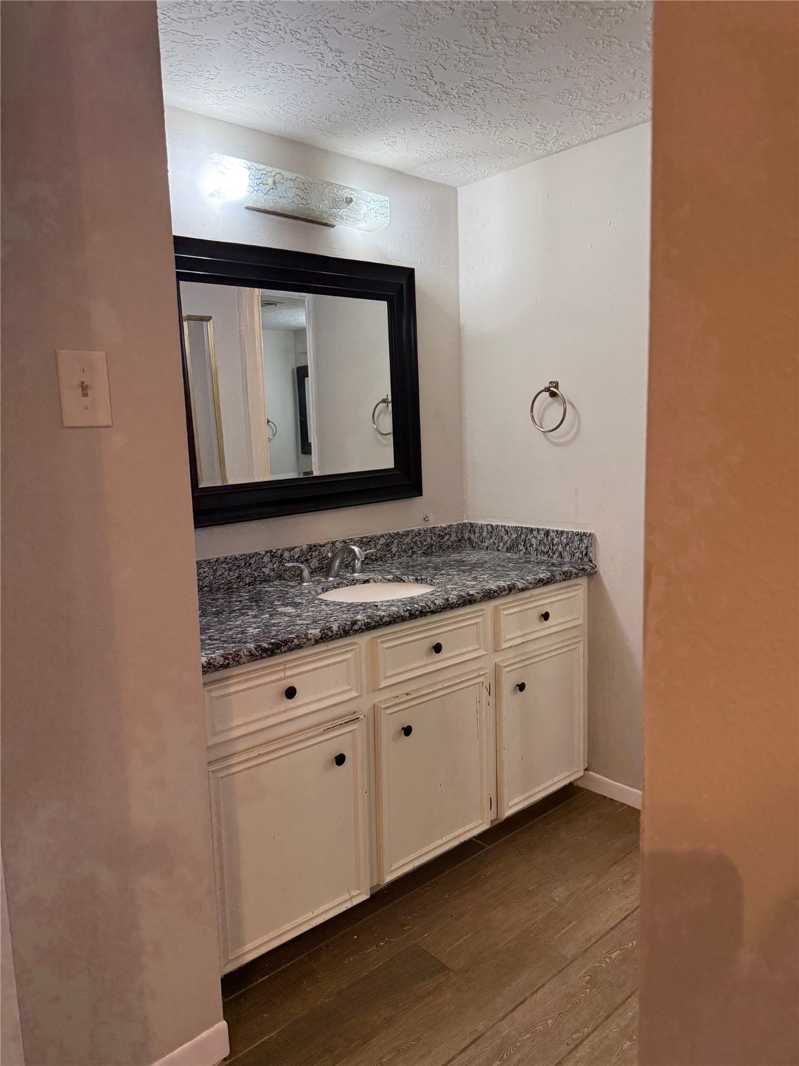 11500 Meadow Lane, Unit 4 Houston, TX 77477 - Photo 12 of 13 a bathroom with a granite countertop sink and a mirror