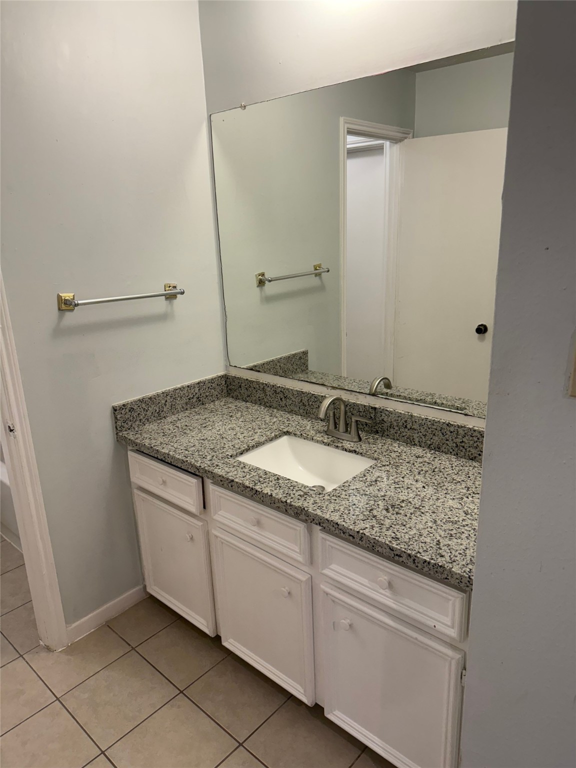 11500 Meadow Lane, Unit 4 Houston, TX 77477 - Photo 13 of 13 a bathroom with a granite countertop sink and a mirror