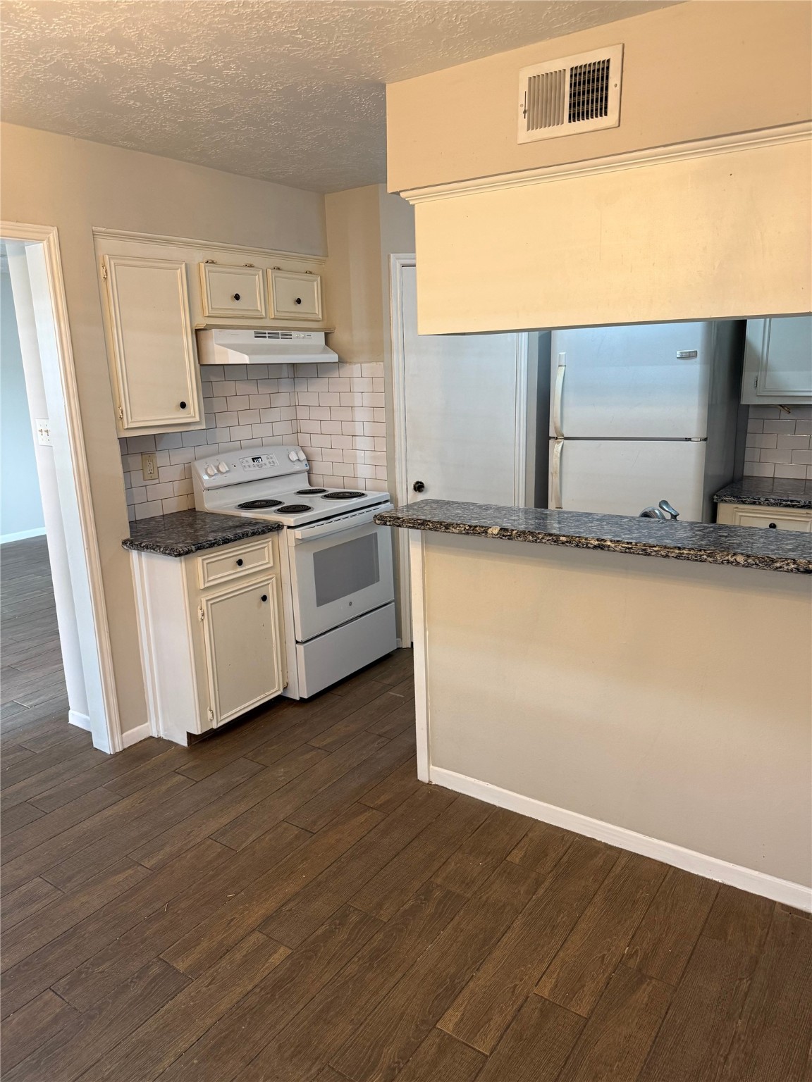 11500 Meadow Lane, Unit 4 Houston, TX 77477 - Photo 4 of 13 a kitchen with stainless steel appliances granite countertop a sink a stove a microwave a sink and cabinets