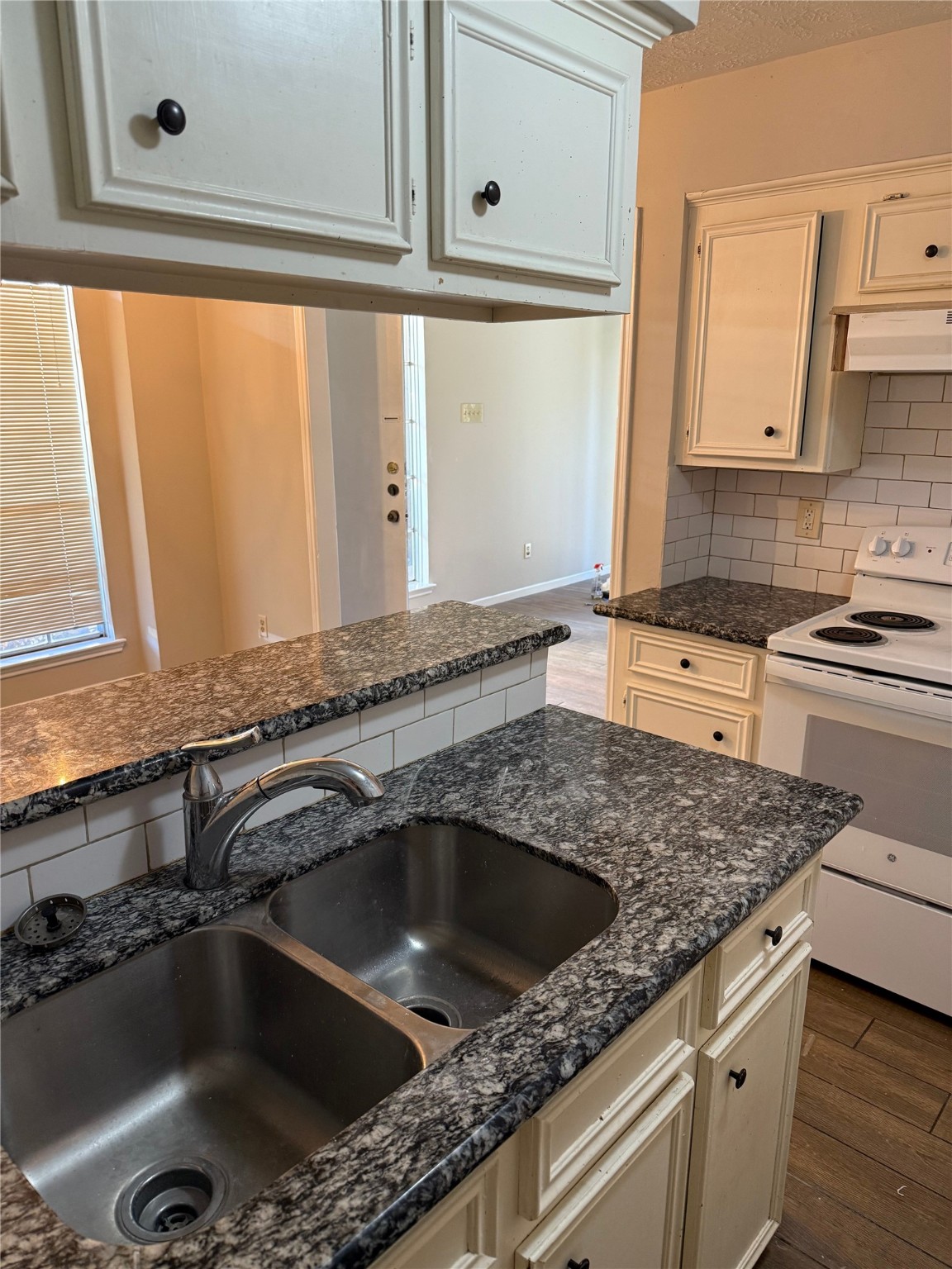 11500 Meadow Lane, Unit 4 Houston, TX 77477 - Photo 6 of 13 a kitchen with granite countertop a sink and a stove