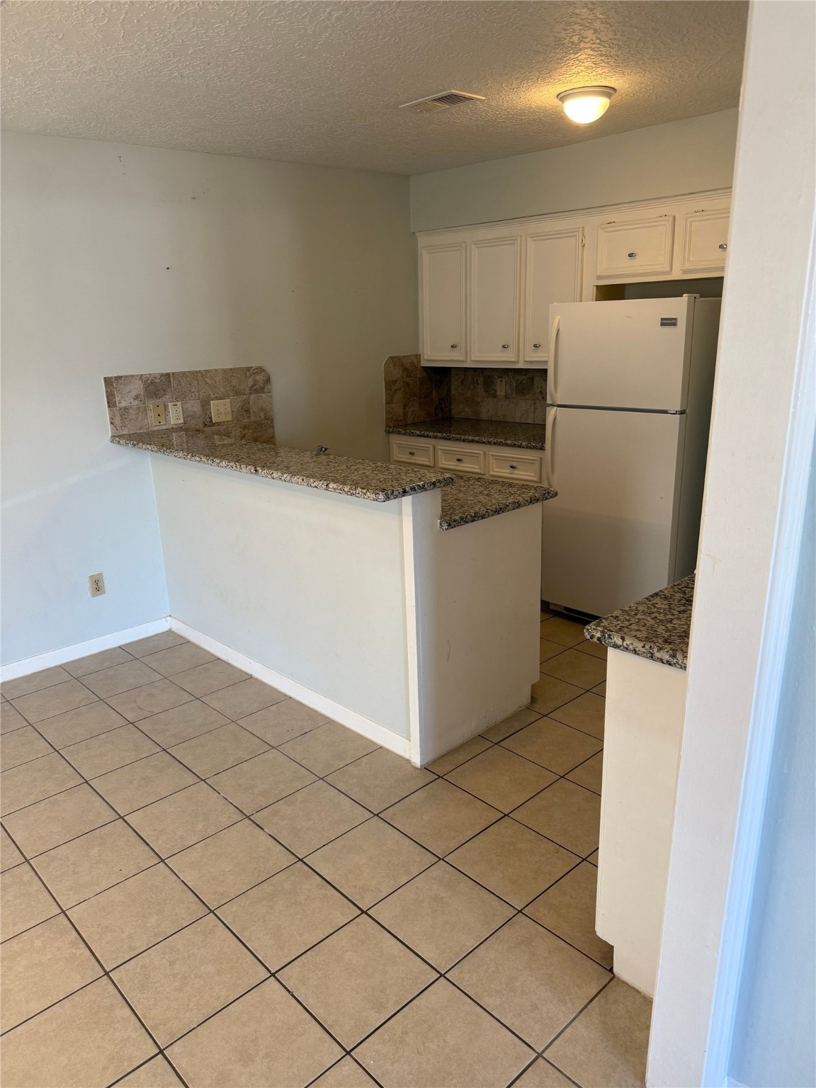 11500 Meadow Lane, Unit 4 Houston, TX 77477 - Photo 7 of 13 a kitchen with a cabinets and a refrigerator