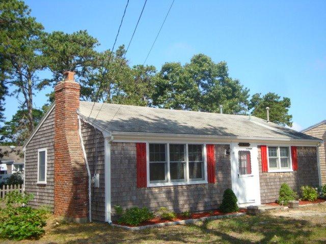 49 Lawrence Road Dennis Port, MA 02639 - Photo 1 of 14 a front view of a house with garden