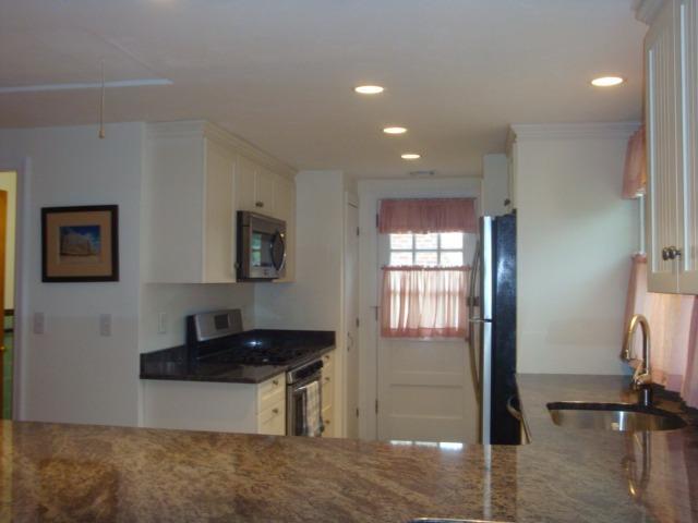 49 Lawrence Road Dennis Port, MA 02639 - Photo 5 of 14 a kitchen with granite countertop a refrigerator and a sink