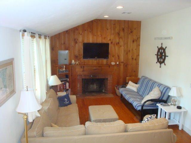 49 Lawrence Road Dennis Port, MA 02639 - Photo 8 of 14 a living room with furniture and a fireplace