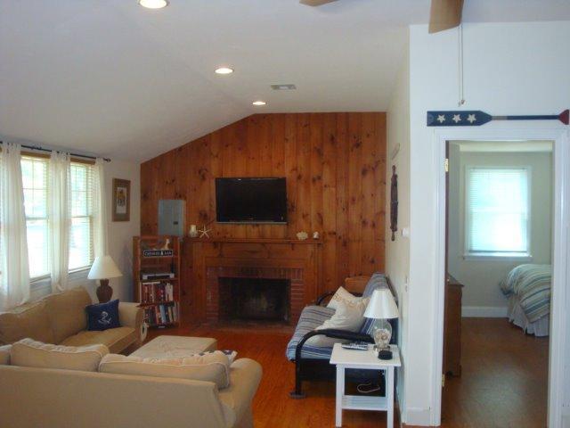 49 Lawrence Road Dennis Port, MA 02639 - Photo 9 of 14 a living room with furniture a flat screen tv and a fireplace