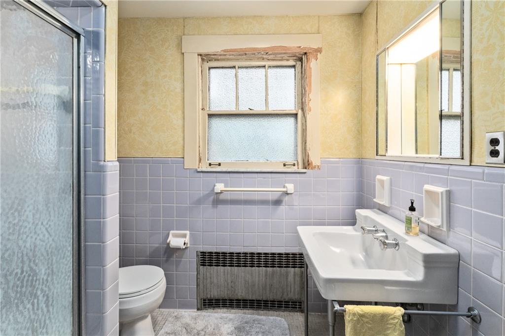 155 Hinkel Road Pittsburgh, PA 15229 - Photo 17 of 40 Vintage bath with pastel lavender tiles, classic pedestal sink, and original frosted-glass window
