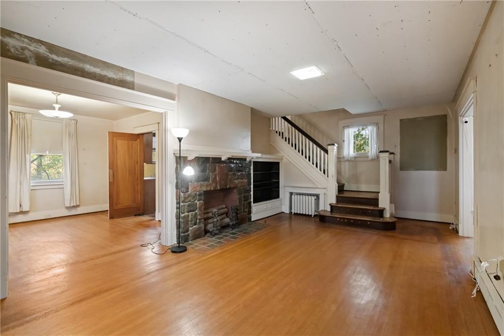 155 Hinkel Road Pittsburgh, PA 15229 - Photo 2 of 40 Step into the spacious living room with gleaming hardwood floors, fireplace, and classic staircase!