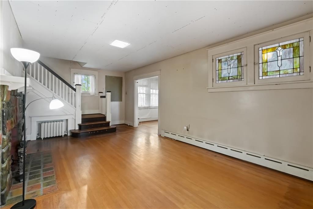 155 Hinkel Road Pittsburgh, PA 15229 - Photo 5 of 40 Twin stained glass windows showcase the authentic 1920s Craftsman charm! The living room flows seemlessly into the sunroom