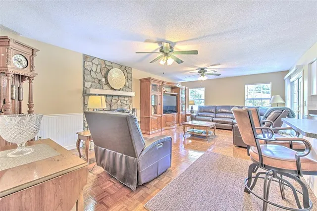 a kitchen with a dining table chairs and sink