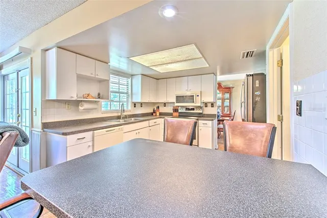 a bathroom with a sink mirror vanity and toilet