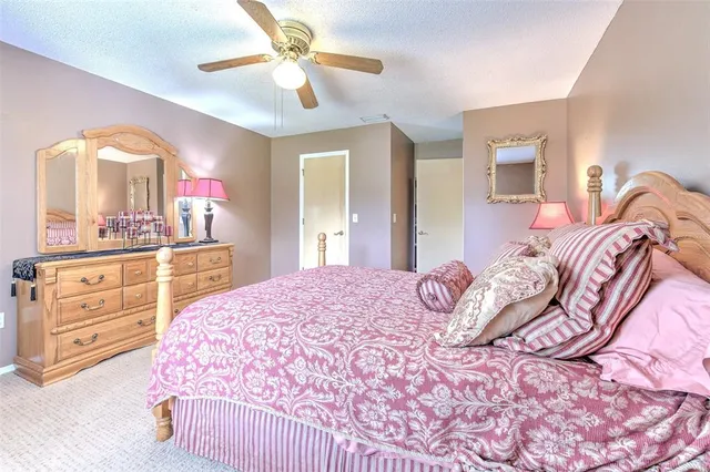 a bedroom with a large bed and a chandelier