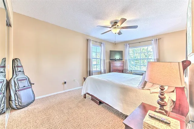 a bathroom with a granite countertop sink a toilet and shower