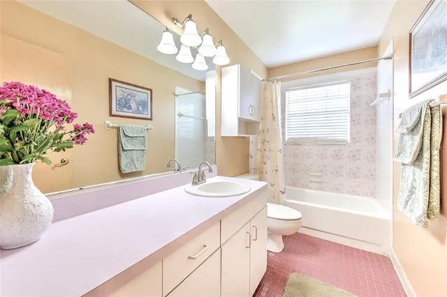 a living room with stainless steel appliances furniture and a window