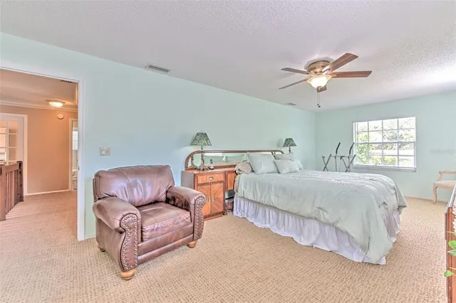 a bedroom with a bed and a couch