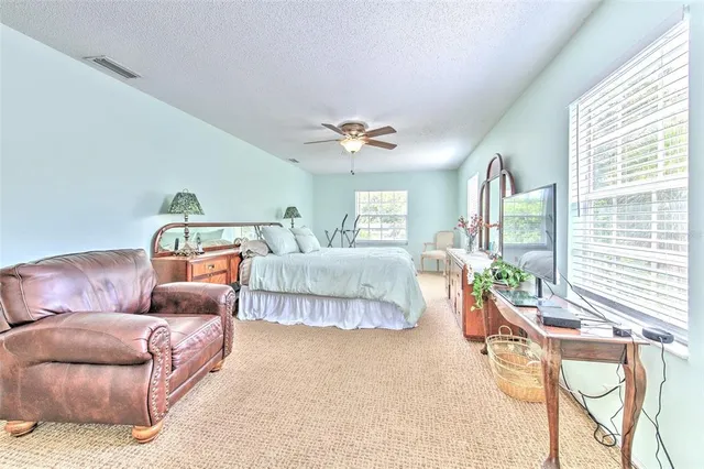 a bathroom with a tub a sink and a large mirror