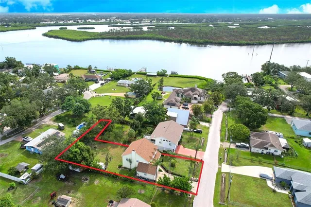 a view of a house with a yard patio and swimming pool