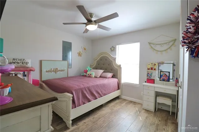 a bedroom with a bed and a wooden floor