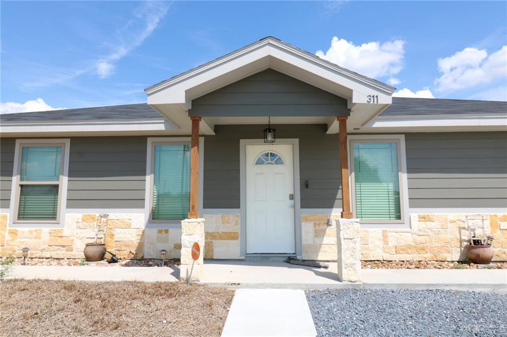 311 Spanish Oak Avenue Rio Grande City, TX 78582 - Photo 2 of 18 a front view of a house with a yard