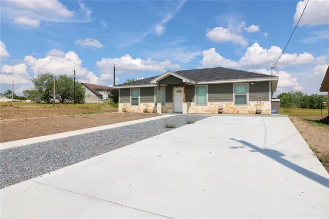 a view of a white house with a yard