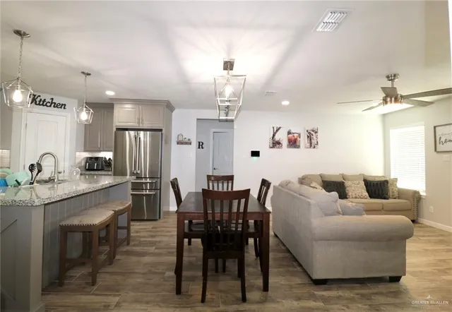 a living room with furniture a dining table and chairs