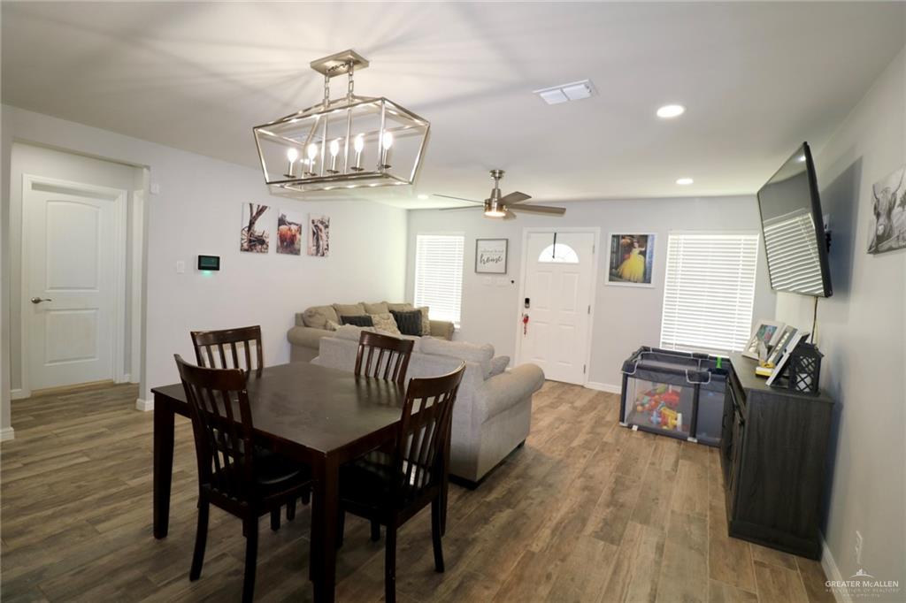 311 Spanish Oak Avenue Rio Grande City, TX 78582 - Photo 10 of 18 a view of a dining room with furniture and wooden floor