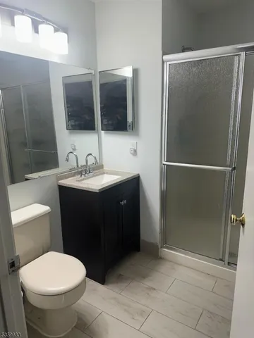 a bathroom with a sink toilet and mirror