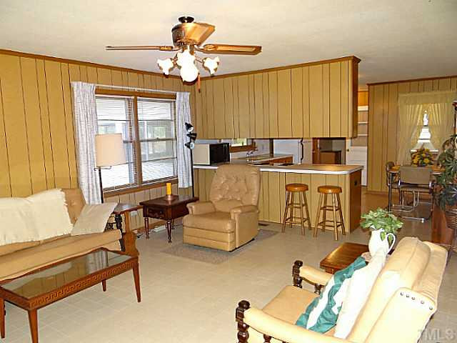 223 Sherron Road Durham, NC 27703 - Photo 8 of 22 a living room with furniture a large window and a chandelier