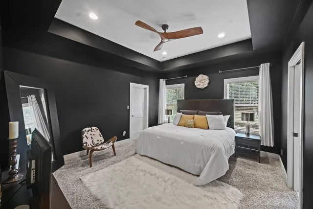 a bedroom with a bed window and a ceiling fan