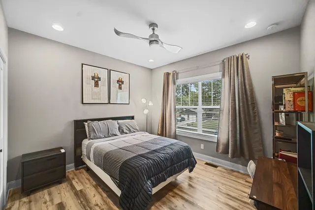 a bedroom with a bed and a flat tv screen