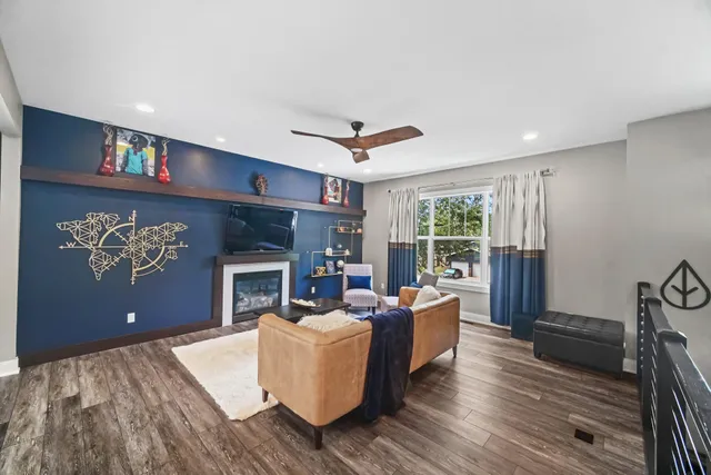 a living room with furniture a fireplace and a flat screen tv