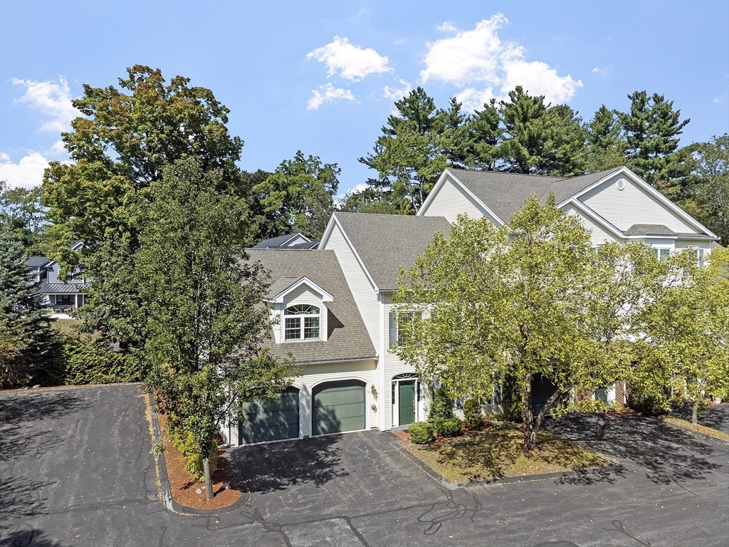 a view of a white house with a yard and plants