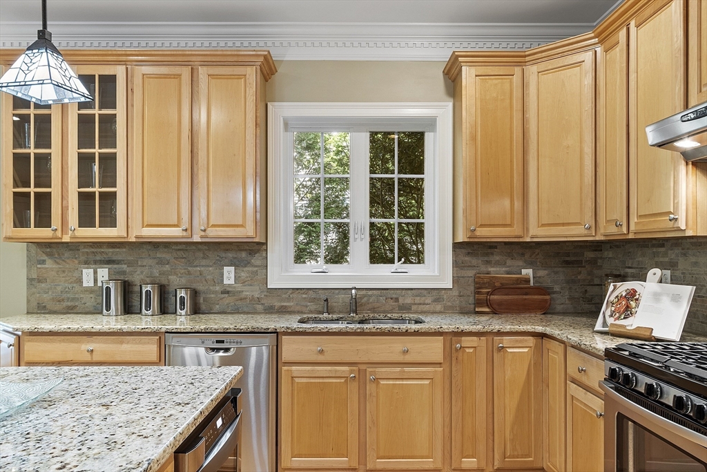 139 Prospect Street, Unit 5 Acton, MA 01720 - Photo 11 of 34 a kitchen with granite countertop a sink stove and cabinets