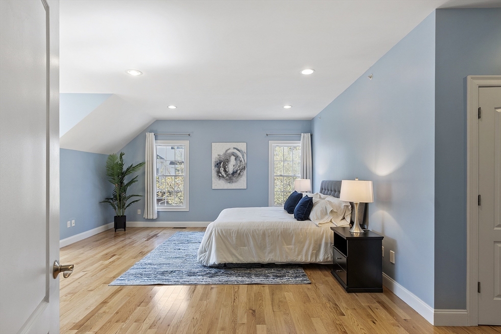 139 Prospect Street, Unit 5 Acton, MA 01720 - Photo 15 of 34 a spacious bedroom with a bed and wooden floor