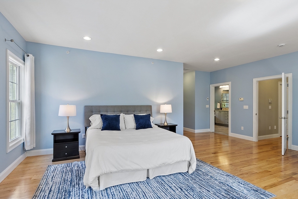 139 Prospect Street, Unit 5 Acton, MA 01720 - Photo 17 of 34 a bedroom with a bed and wooden floor