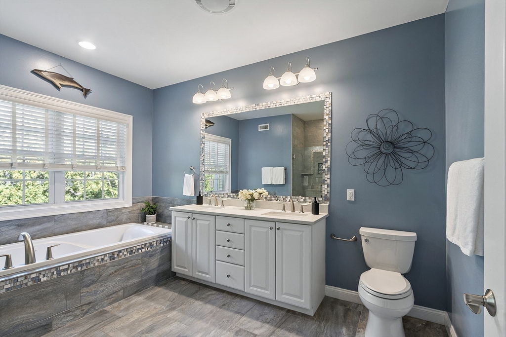 139 Prospect Street, Unit 5 Acton, MA 01720 - Photo 19 of 34 a bathroom with a double vanity sink a toilet and a bathtub