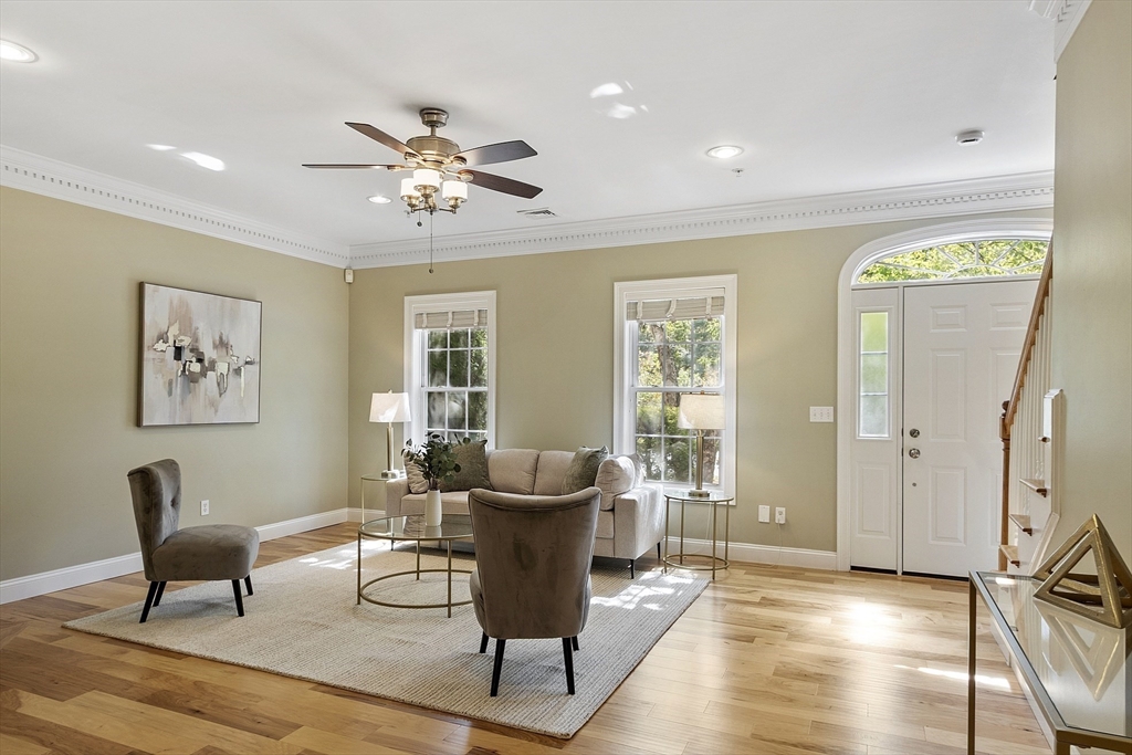 139 Prospect Street, Unit 5 Acton, MA 01720 - Photo 2 of 34 a living room with furniture a window and a chandelier