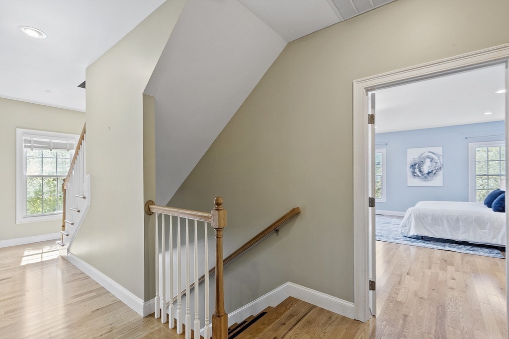 139 Prospect Street, Unit 5 Acton, MA 01720 - Photo 27 of 34 a view of a livingroom with wooden floor and stairs