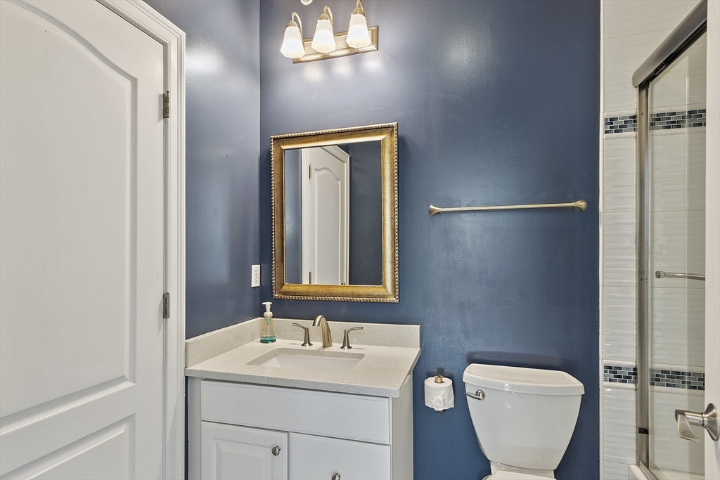 139 Prospect Street, Unit 5 Acton, MA 01720 - Photo 30 of 34 a bathroom with a toilet sink and mirror