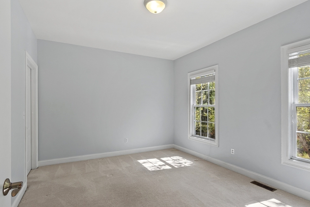 139 Prospect Street, Unit 5 Acton, MA 01720 - Photo 31 of 34 an empty room with windows