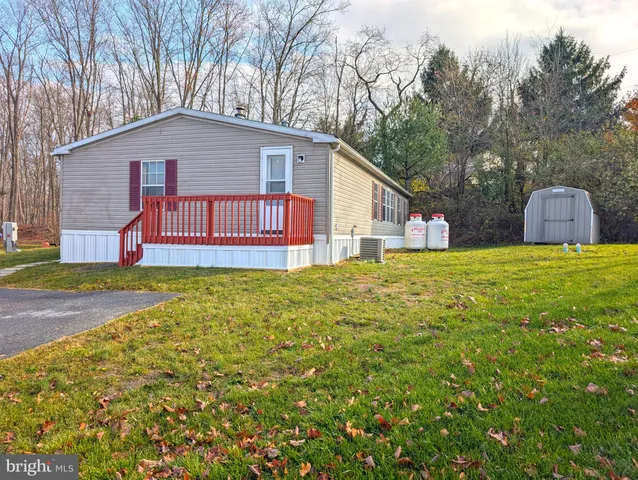 a view of a house with a yard and garage