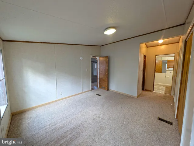 a bathroom with a granite countertop sink a mirror a bathtub and shower