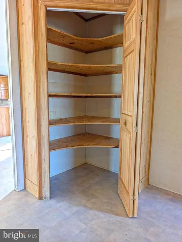 a view of a livingroom with a window and a ceiling fan