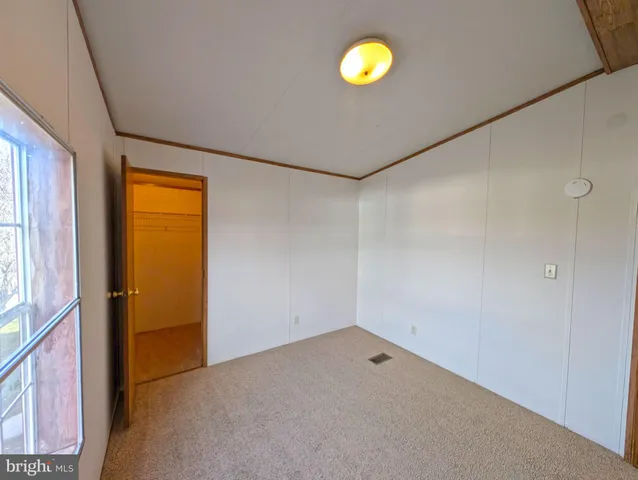 an empty room with wooden door and a window