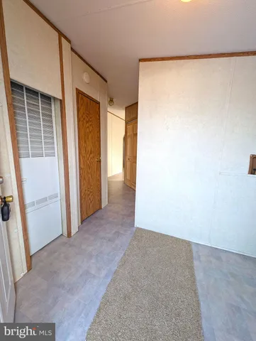 a view of backyard of house with wooden fence and trees