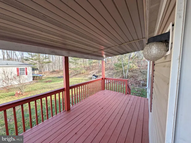 a view of a balcony with wooden floor