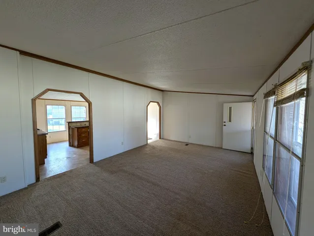 a view of a big room with staircase and door